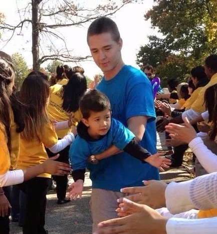 Image of Volunteer holding boy